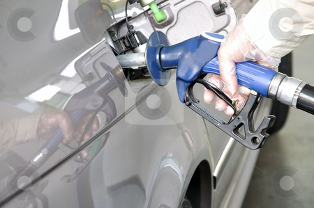 To use this stock image in your creative project, please select the size you need over to the right and click the "Add to Cart" button.
Your downloaded image will come with the Cutcaster watermark removed so don’t worry about the watermark you see on this page. At the petrol station. stock photo, Close-up of a man's hand using a petrol pump to fill his car up with fuel. by Liana Bukhtyyarova