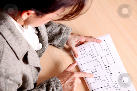 To use this stock image in your creative project, please select the size you need over to the right and click the "Add to Cart" button.
Your downloaded image will come with the Cutcaster watermark removed so don’t worry about the watermark you see on this page. Architecture stock photo, Woman pointing to some architectural drawings. Architecture image by Giuseppe Ramos
