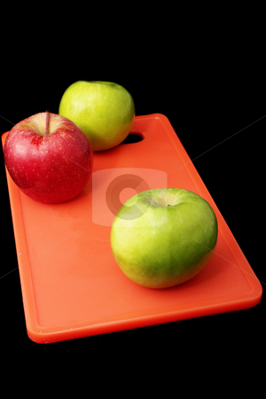 To use this stock image in your creative project, please select the size you need over to the right and click the "Add to Cart" button.
Your downloaded image will come with the Cutcaster watermark removed so don’t worry about the watermark you see on this page. Apple #5 stock photo, Green and red apples on red plastic cutting board - black background by Sean Nel