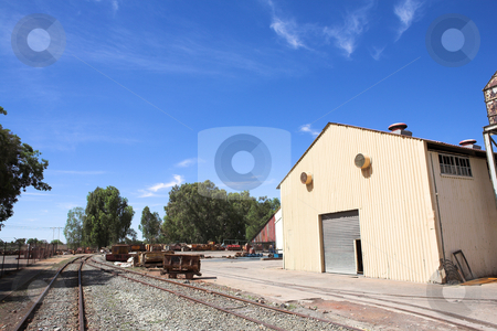 To use this stock image in your creative project, please select the size you need over to the right and click the "Add to Cart" button.
Your downloaded image will come with the Cutcaster watermark removed so don’t worry about the watermark you see on this page. Industrial type warehouse and factory stock photo, Rusted metal mining wagons standing outside an industrial warehouse with train tracks running in front of the building. Blue sky and sunny day by Sean Nel