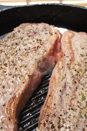 To use this stock image in your creative project, please select the size you need over to the right and click the "Add to Cart" button.
Your downloaded image will come with the Cutcaster watermark removed so don’t worry about the watermark you see on this page. Cooked meat stock photo, Cooked steaks being prepared in a black cast iron skillet by Sean Nel