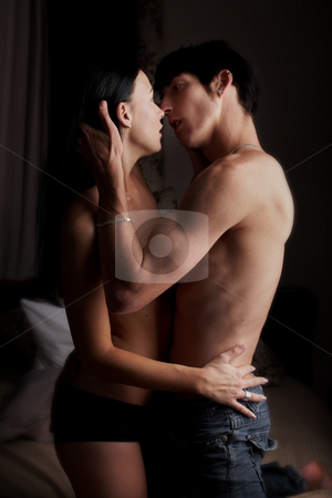 To use this stock image in your creative project, please select the size you need over to the right and click the "Add to Cart" button.
Your downloaded image will come with the Cutcaster watermark removed so don’t worry about the watermark you see on this page. Intimate young lovers stock photo, Young adult Caucasian couple in passionate embrace and undressing each other during sexual foreplay by Sean Nel