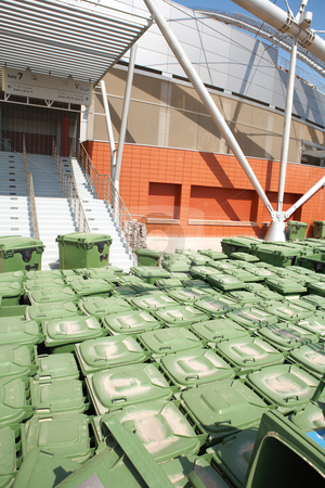 To use this stock image in your creative project, please select the size you need over to the right and click the "Add to Cart" button.
Your downloaded image will come with the Cutcaster watermark removed so don’t worry about the watermark you see on this page. Rubbish bins stock photo, Stacks of green rubbish bins standing outside a sports stadium. by Sean Nel