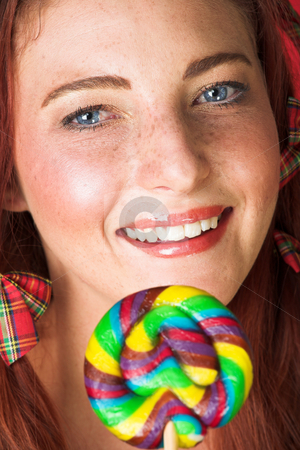 To use this stock image in your creative project, please select the size you need over to the right and click the "Add to Cart" button.
Your downloaded image will come with the Cutcaster watermark removed so don’t worry about the watermark you see on this page. Female Fashion Model stock photo, Young female adult fashion model with natural red hair and freckles in a yellow bikini with a big multi-colored lollipop (textured red faux leather background) by Sean Nel