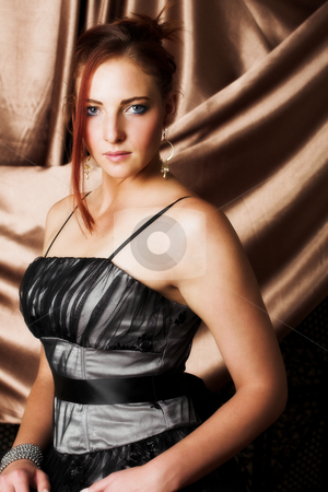 To use this stock image in your creative project, please select the size you need over to the right and click the "Add to Cart" button.
Your downloaded image will come with the Cutcaster watermark removed so don’t worry about the watermark you see on this page. Sexy adult woman stock photo, Beautiful young sexy adult Redheaded woman with long auburn hair, in formal black dress on a textured silk background ? Hard light, high key. Defucussed by Sean Nel