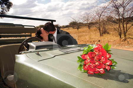 To use this stock image in your creative project, please select the size you need over to the right and click the "Add to Cart" button.
Your downloaded image will come with the Cutcaster watermark removed so don’t worry about the watermark you see on this page. Bridal Couple #49 stock photo, Red bouquet of roses on the bonnet of a car, just married bridal couple kissing in the background. Focus on Flowers by Sean Nel