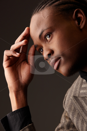 To use this stock image in your creative project, please select the size you need over to the right and click the "Add to Cart" button.
Your downloaded image will come with the Cutcaster watermark removed so don’t worry about the watermark you see on this page. Black Businessman stock photo, Black African businessman on a dark background in various positions and with various facial expressions. Part of a series by Sean Nel