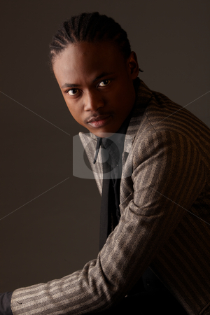 To use this stock image in your creative project, please select the size you need over to the right and click the "Add to Cart" button.
Your downloaded image will come with the Cutcaster watermark removed so don’t worry about the watermark you see on this page. Black Businessman stock photo, Black African businessman on a dark background in various positions and with various facial expressions. Part of a series by Sean Nel