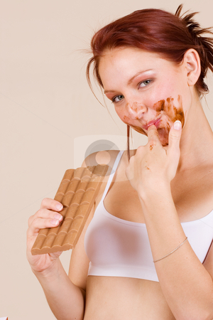 To use this stock image in your creative project, please select the size you need over to the right and click the "Add to Cart" button.
Your downloaded image will come with the Cutcaster watermark removed so don’t worry about the watermark you see on this page. Chocolate #4 stock photo, Redheaded girl eating chocolate by Sean Nel