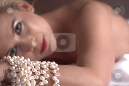 To use this stock image in your creative project, please select the size you need over to the right and click the "Add to Cart" button.
Your downloaded image will come with the Cutcaster watermark removed so don’t worry about the watermark you see on this page. Nude adult woman stock photo, Sensual naked young blonde adult Caucasian woman, wrapped in a satin, silk sheet on a bed in her bedroom. High contrast lighting. Very Shallow DOF, Focus on the pearls by Sean Nel