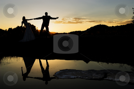 To use this stock image in your creative project, please select the size you need over to the right and click the "Add to Cart" button.
Your downloaded image will come with the Cutcaster watermark removed so don’t worry about the watermark you see on this page. Couple #2 stock photo, Bride and groom next to river at sunset by Sean Nel