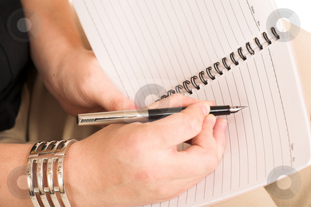 To use this stock image in your creative project, please select the size you need over to the right and click the "Add to Cart" button.
Your downloaded image will come with the Cutcaster watermark removed so don’t worry about the watermark you see on this page. Business Woman #507 stock photo, Business Woman, wearing black top and beige pants, writing with pen in notebook by Sean Nel