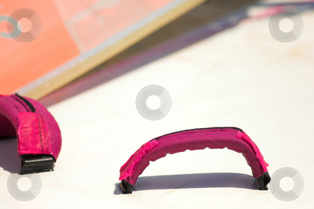 To use this stock image in your creative project, please select the size you need over to the right and click the "Add to Cart" button.
Your downloaded image will come with the Cutcaster watermark removed so don’t worry about the watermark you see on this page. Windsurfer board straps stock photo, Pink board straps and foot holds on a windsurfing board by Sean Nel