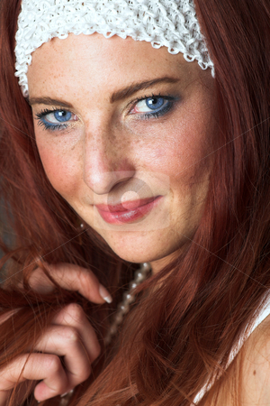 To use this stock image in your creative project, please select the size you need over to the right and click the "Add to Cart" button.
Your downloaded image will come with the Cutcaster watermark removed so don’t worry about the watermark you see on this page. Female Fashion Model stock photo, Young female adult fashion model with natural red hair and freckles in a white summers dress and white headband (textured wooden background) by Sean Nel
