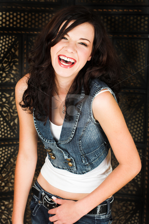 To use this stock image in your creative project, please select the size you need over to the right and click the "Add to Cart" button.
Your downloaded image will come with the Cutcaster watermark removed so don’t worry about the watermark you see on this page. Young brunette woman stock photo, Young adult brunette woman with a white top and long brown curly hair and brown eyes looking at the camera and laughing by Sean Nel