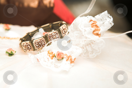 To use this stock image in your creative project, please select the size you need over to the right and click the "Add to Cart" button.
Your downloaded image will come with the Cutcaster watermark removed so don’t worry about the watermark you see on this page. Bracelet and Garter stock photo, Brown flower bracelet and lace bridal garter lying on a bed by Sean Nel