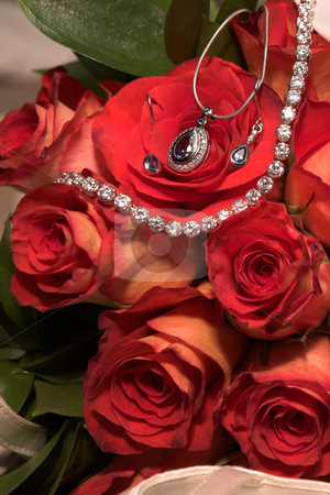 To use this stock image in your creative project, please select the size you need over to the right and click the "Add to Cart" button.
Your downloaded image will come with the Cutcaster watermark removed so don’t worry about the watermark you see on this page. Jewelry in Wedding bouquet stock photo, Expensive Jewelry in red rose wedding bouquet by Sean Nel