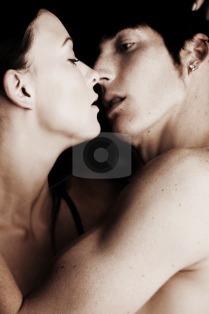 To use this stock image in your creative project, please select the size you need over to the right and click the "Add to Cart" button.
Your downloaded image will come with the Cutcaster watermark removed so don’t worry about the watermark you see on this page. Intimate young lovers stock photo, Young adult Caucasian couple in passionate embrace and undressing each other during sexual foreplay by Sean Nel