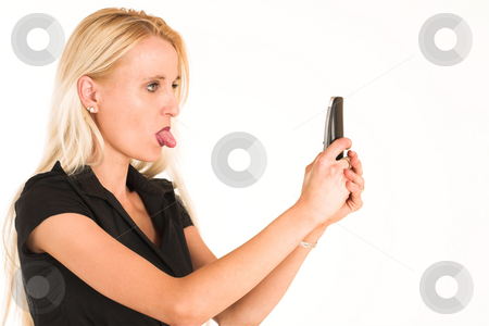 To use this stock image in your creative project, please select the size you need over to the right and click the "Add to Cart" button.
Your downloaded image will come with the Cutcaster watermark removed so don’t worry about the watermark you see on this page. Business Woman #377 stock photo, Blond business woman, dressed in a black clothes. Sticking her tongue out to her cellphone. Copy space. by Sean Nel