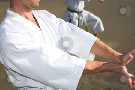 To use this stock image in your creative project, please select the size you need over to the right and click the "Add to Cart" button.
Your downloaded image will come with the Cutcaster watermark removed so don’t worry about the watermark you see on this page. Men practicing Karate on the beach stock photo, Young adult men with black belt practicing a Kata on the beach on a sunny day by Sean Nel