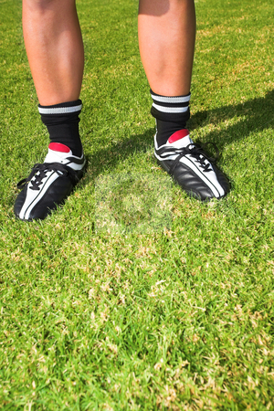 To use this stock image in your creative project, please select the size you need over to the right and click the "Add to Cart" button.
Your downloaded image will come with the Cutcaster watermark removed so don’t worry about the watermark you see on this page. Football player on soccer pitch stock photo, A male soccer (football) player, referee or coach standing on a soccer pitch. The image is of feet and legs, with soccer togs. copy space on de-focused grass by Sean Nel