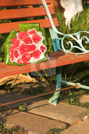 To use this stock image in your creative project, please select the size you need over to the right and click the "Add to Cart" button.
Your downloaded image will come with the Cutcaster watermark removed so don’t worry about the watermark you see on this page. Wedding bouquet stock photo, Red rose wedding bouquet on a wooden bench in the garden draped in a white veil. Lying in the sunlight by Sean Nel