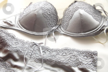To use this stock image in your creative project, please select the size you need over to the right and click the "Add to Cart" button.
Your downloaded image will come with the Cutcaster watermark removed so don’t worry about the watermark you see on this page. Silver lace Lingerie stock photo, Pair of silver lace lingerie, bra and panties lying on a bed by Sean Nel