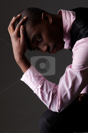 To use this stock image in your creative project, please select the size you need over to the right and click the "Add to Cart" button.
Your downloaded image will come with the Cutcaster watermark removed so don’t worry about the watermark you see on this page. Black African businessman stock photo, Young Adult black african businessman wearing a dark smart-casual outfit without a Jacket, but with a pink shirt and a dark waistcoat on a dark grey background in various poses with various facial expressions. Part of a series, Not Isolated. Single lightsource, hard shadows by Sean Nel