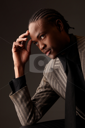 To use this stock image in your creative project, please select the size you need over to the right and click the "Add to Cart" button.
Your downloaded image will come with the Cutcaster watermark removed so don’t worry about the watermark you see on this page. Black Businessman stock photo, Black African businessman on a dark background in various positions and with various facial expressions. Part of a series by Sean Nel