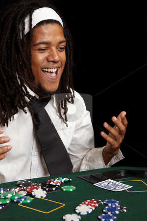To use this stock image in your creative project, please select the size you need over to the right and click the "Add to Cart" button.
Your downloaded image will come with the Cutcaster watermark removed so don’t worry about the watermark you see on this page. Card gambling stock photo, Young African man with dreadlocks playing cards, chips and players gambling around a green felt poker table. Shallow Depth of field by Sean Nel