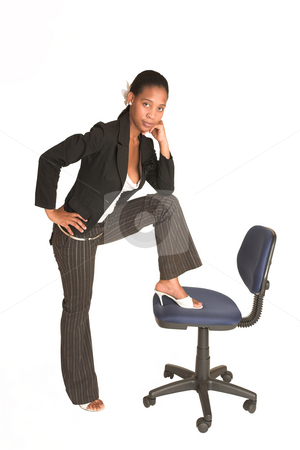 To use this stock image in your creative project, please select the size you need over to the right and click the "Add to Cart" button.
Your downloaded image will come with the Cutcaster watermark removed so don’t worry about the watermark you see on this page. Mida Matsimela #26 stock photo, African business woman dressed in black jacket. Standing with one foot on an office chair. by Sean Nel