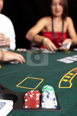 To use this stock image in your creative project, please select the size you need over to the right and click the "Add to Cart" button.
Your downloaded image will come with the Cutcaster watermark removed so don’t worry about the watermark you see on this page. Card gambling stock photo, People playing cards, chips and players gambling around a green felt poker table. Shallow Depth of field by Sean Nel