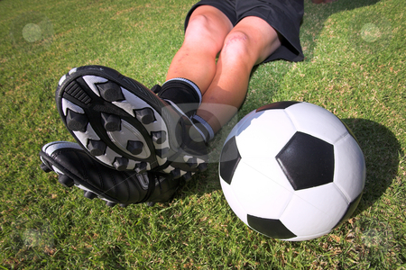 To use this stock image in your creative project, please select the size you need over to the right and click the "Add to Cart" button.
Your downloaded image will come with the Cutcaster watermark removed so don’t worry about the watermark you see on this page. Football player with a soccerball on soccer pitch stock photo, A male soccer (football) player, referee or coach sitting with crossed legs. Focus on ball and togs by Sean Nel