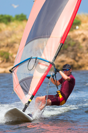 To use this stock image in your creative project, please select the size you need over to the right and click the "Add to Cart" button.
Your downloaded image will come with the Cutcaster watermark removed so don’t worry about the watermark you see on this page. Man in wetsuit on fastmoving windsurfer stock photo, Fast moving windsurfer on the water at Keurbooms Lagoon, South Africa by Sean Nel