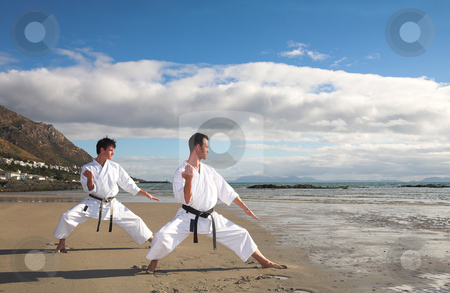 To use this stock image in your creative project, please select the size you need over to the right and click the "Add to Cart" button.
Your downloaded image will come with the Cutcaster watermark removed so don’t worry about the watermark you see on this page. Men practicing Karate on the beach stock photo, Young adult men with black belt practicing a Kata on the beach on a sunny day by Sean Nel