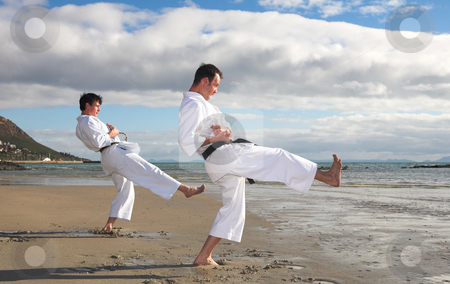 To use this stock image in your creative project, please select the size you need over to the right and click the "Add to Cart" button.
Your downloaded image will come with the Cutcaster watermark removed so don’t worry about the watermark you see on this page. Men practicing Karate on the beach stock photo, Young adult men with black belt practicing a Kata on the beach on a sunny day by Sean Nel