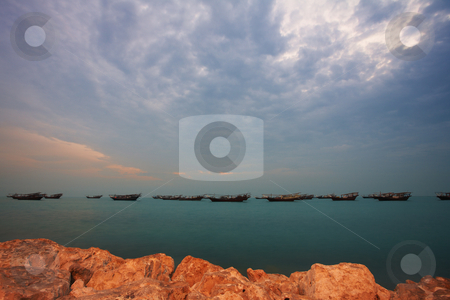 To use this stock image in your creative project, please select the size you need over to the right and click the "Add to Cart" button.
Your downloaded image will come with the Cutcaster watermark removed so don’t worry about the watermark you see on this page. Dhows at sunrise stock photo, Fishing dhows at the harbour of the old pearling town of Al Wakrah in Qatar, Middle East, right before sunrise (movement on the Dhows) by Sean Nel