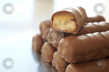 To use this stock image in your creative project, please select the size you need over to the right and click the "Add to Cart" button.
Your downloaded image will come with the Cutcaster watermark removed so don’t worry about the watermark you see on this page. Chocolate bar tower stock photo, Tower of thin chocolate bars with one broken bar, caramel toffee spilling out by Sean Nel