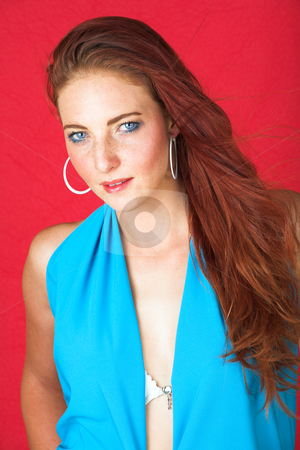 To use this stock image in your creative project, please select the size you need over to the right and click the "Add to Cart" button.
Your downloaded image will come with the Cutcaster watermark removed so don’t worry about the watermark you see on this page. Female Fashion Model stock photo, Young female adult fashion model with natural red hair and freckles in a blue summers dress with white belt (red textured faux leather background) by Sean Nel