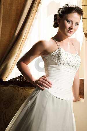 To use this stock image in your creative project, please select the size you need over to the right and click the "Add to Cart" button.
Your downloaded image will come with the Cutcaster watermark removed so don’t worry about the watermark you see on this page. Beautiful young bride stock photo, Slim beautiful adult woman with long brown, curly hair wearing luxurious silk wedding dress on location by Sean Nel