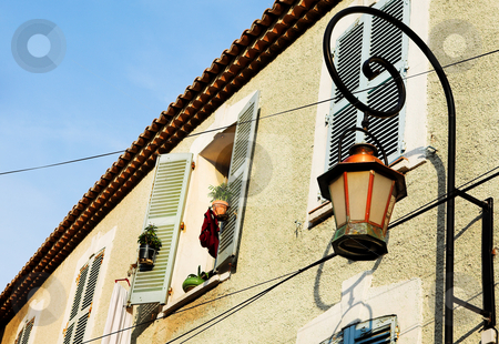 To use this stock image in your creative project, please select the size you need over to the right and click the "Add to Cart" button.
Your downloaded image will come with the Cutcaster watermark removed so don’t worry about the watermark you see on this page. Building in Antibes stock photo, Building with shutters on windows and street light in Antibes, France. by Sean Nel