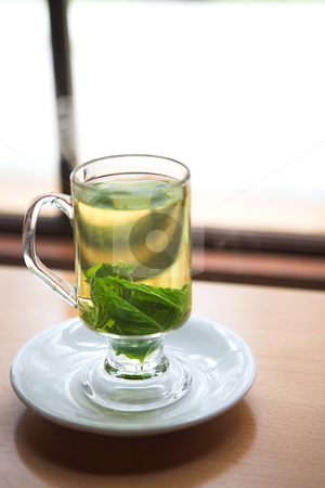 To use this stock image in your creative project, please select the size you need over to the right and click the "Add to Cart" button.
Your downloaded image will come with the Cutcaster watermark removed so don’t worry about the watermark you see on this page. Green mint tea stock photo, Hot green mint tea standing next to a window with whole mint leaves (shallow Depth of Field) by Sean Nel