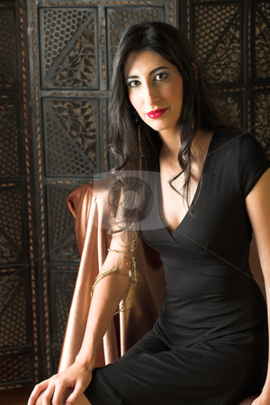 To use this stock image in your creative project, please select the size you need over to the right and click the "Add to Cart" button.
Your downloaded image will come with the Cutcaster watermark removed so don’t worry about the watermark you see on this page. Italian adult woman stock photo, Beautiful young sexy adult Italian woman with long black hair, in formal black dress on a textured wooden background, sitting on a luxurious couch ? Hard light, high key by Sean Nel