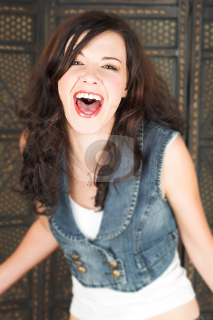To use this stock image in your creative project, please select the size you need over to the right and click the "Add to Cart" button.
Your downloaded image will come with the Cutcaster watermark removed so don’t worry about the watermark you see on this page. Young brunette woman stock photo, Young adult brunette woman with a white top and long brown curly hair and brown eyes looking at the camera and screaming by Sean Nel