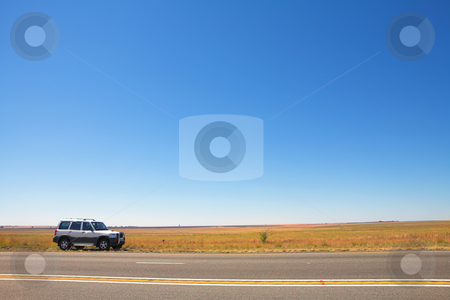 To use this stock image in your creative project, please select the size you need over to the right and click the "Add to Cart" button.
Your downloaded image will come with the Cutcaster watermark removed so don’t worry about the watermark you see on this page. Car next to the road stock photo, SUV parked next to the road on an open stretch of highway with very little on the landscape. Blue sky provides copy space. by Sean Nel