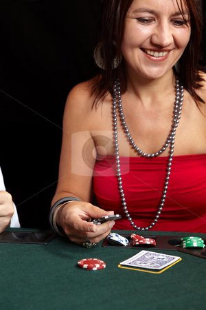 To use this stock image in your creative project, please select the size you need over to the right and click the "Add to Cart" button.
Your downloaded image will come with the Cutcaster watermark removed so don’t worry about the watermark you see on this page. Card gambling stock photo, People playing cards, chips and players gambling around a green felt poker table. Shallow Depth of field. Focus on the Hand and Chips by Sean Nel