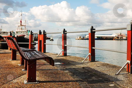To use this stock image in your creative project, please select the size you need over to the right and click the "Add to Cart" button.
Your downloaded image will come with the Cutcaster watermark removed so don’t worry about the watermark you see on this page. Benches at the harbour stock photo, Two red seats at the Cape Town Waterfront harbour in South Africa, with boats in the background on a cloudy day. by Sean Nel