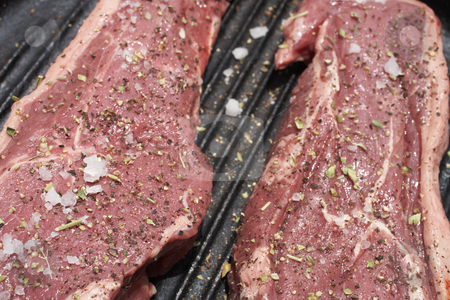 To use this stock image in your creative project, please select the size you need over to the right and click the "Add to Cart" button.
Your downloaded image will come with the Cutcaster watermark removed so don’t worry about the watermark you see on this page. Raw meat stock photo, Raw steaks being prepared in a black cast iron skillet by Sean Nel