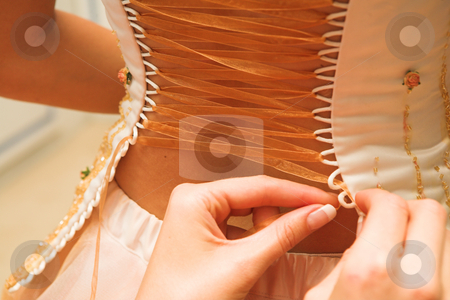To use this stock image in your creative project, please select the size you need over to the right and click the "Add to Cart" button.
Your downloaded image will come with the Cutcaster watermark removed so don’t worry about the watermark you see on this page. Bride #8 stock photo, Bride getting dressed, Bare back - Ribbon being threaded. Focus on the Ribbons by Sean Nel