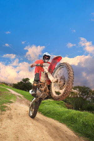 To use this stock image in your creative project, please select the size you need over to the right and click the "Add to Cart" button.
Your downloaded image will come with the Cutcaster watermark removed so don’t worry about the watermark you see on this page. Offroad Bike stock photo, Young man riding around on his dirtbike doing tricks and getting dirty. Movement on edges of motorbike by Sean Nel